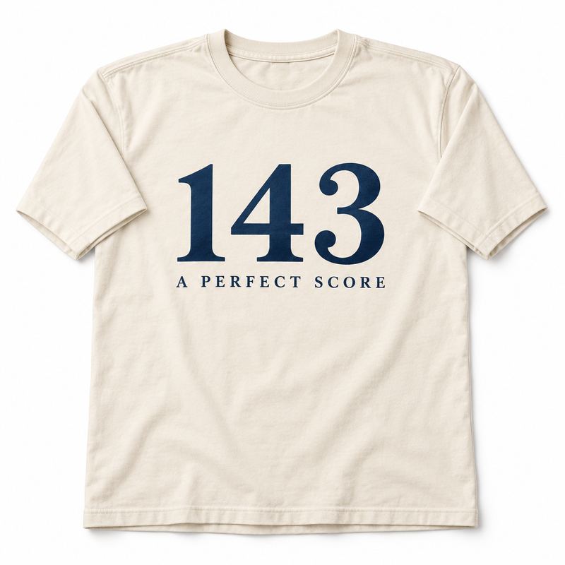 A natural ivory T-shirt printed with the numerals 143 in navy serif and the words A PERFECT SCORE beneath.